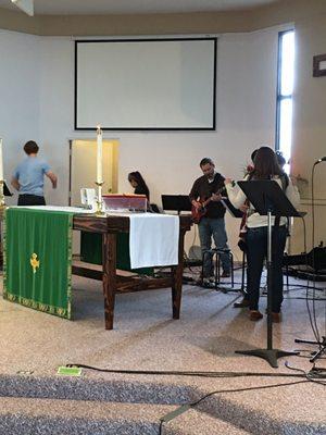 The musicians practicing before and after services. They are great musician/singers.