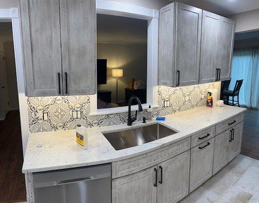 Installed a opening above the sink along with new cabinets and backsplash