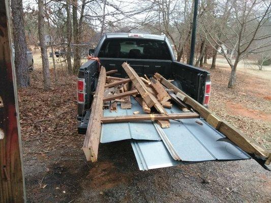 Debris being hauled off from the top of shed