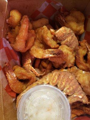 Container with fried shrimp and lobster tail.