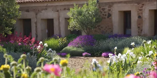 Mediterranean theme with clean stone, low maintenance and great use of space to create balance with such a large residence.