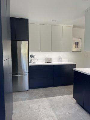 Modern Kitchen Complete Remodel. Beautiful custom cabinets finished with cool white uppers and navy lowers.