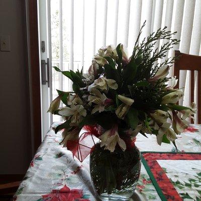 The full view of the bouquet my mom received showing more greenery than flowers and the droopy flowers.