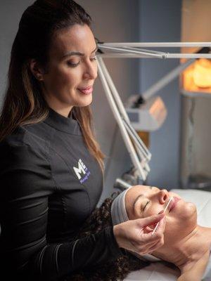 Estheticians use facial serums and exfoliant lip treatments as part of the facial spa experience.