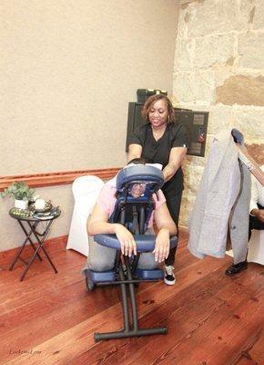 Your Me Time Massage & Bodywork owner, Temkia Hines, catering to the community by offering chair massage.