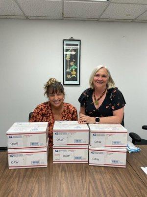 President & CEO Cambria Tortorelli (right) and manager of our Afghan Legal Representation Project (ALRP) with finished asylum applications.