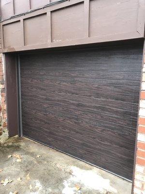 Flush panel door with one of our new colors... walnut. All metal door with wood look