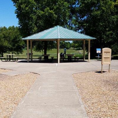 small shelter in the middle of the park