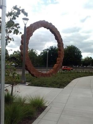 I kinda like it, I admit. Up close it looks like stumps of wood Timber Joey cut or from a distance a giant chain from a bicycle.