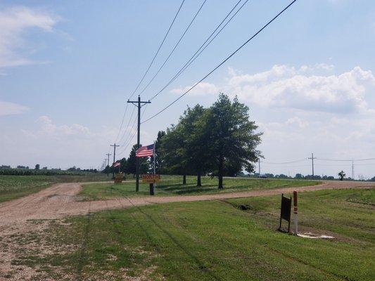 The drive into 61 Produce. He has American Flags and large yellow signs to alert to his presence.