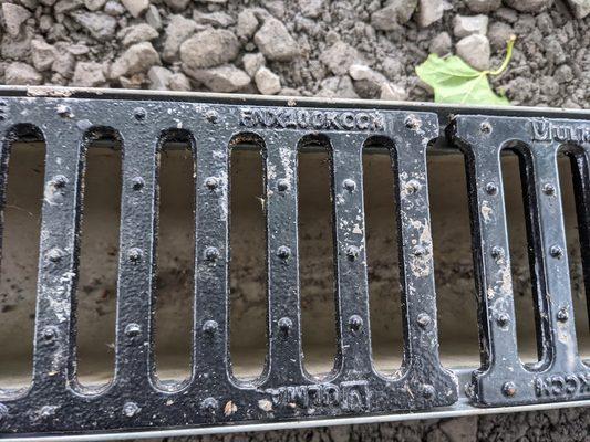 Grate chosen by Jim Spano. Note that 20ft of this exact trench drain and grate only cost $1,033 via Trench Drain Supply.