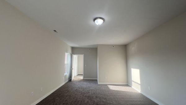 A very large bedroom with walk-in closets and a walkout patio at Cinema Apartments.