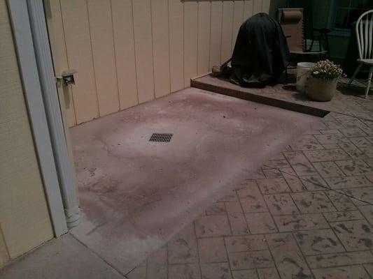 Concrete patio that is worn and dated before epoxy coating.