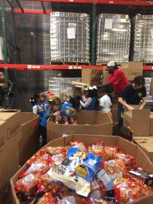 Girl Scout Troop #10664 sorting through candy to help at the Greater Baton Rouge Food Bank!