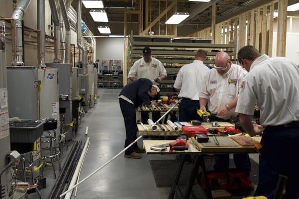 Students learn to penetrate various field materials in Total Tech's Plumbing Fundamentals class.