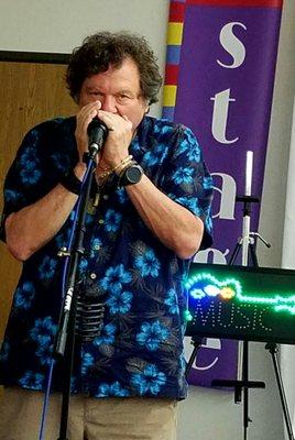 Red Sky Stage owner Marty Scott playing the blues harp.