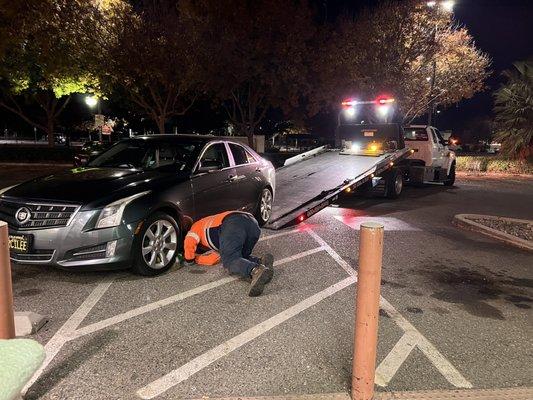 Driver Bob working to get my car onto the truck. He had his hands full as steering wheel wouldn't lock and car couldn't change gears.