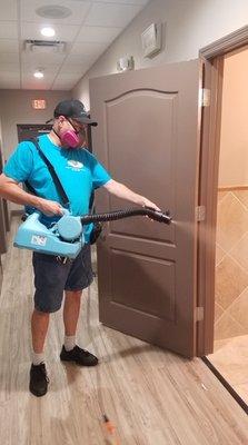 Using a fogger to disinfect a commercial bathroom.