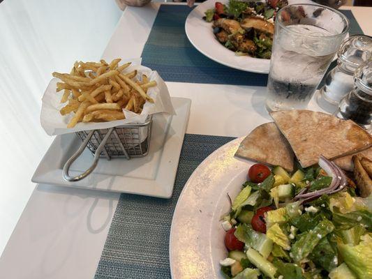 Mediterranean salad with grilled chicken and French fries