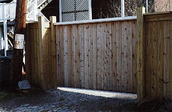 Custom aluminum slide gate with cedar privacy fill.