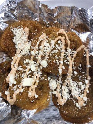 Fried Green tomatoes drizzled with house sauce sprinkled with feta cheese