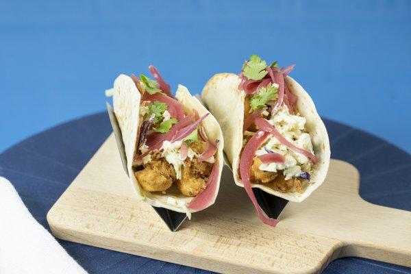 Spicy buttermilk Cauliflower with a charred jalapeno slaw mix, pickled onions, topped w/cilantro on a flour tortilla.