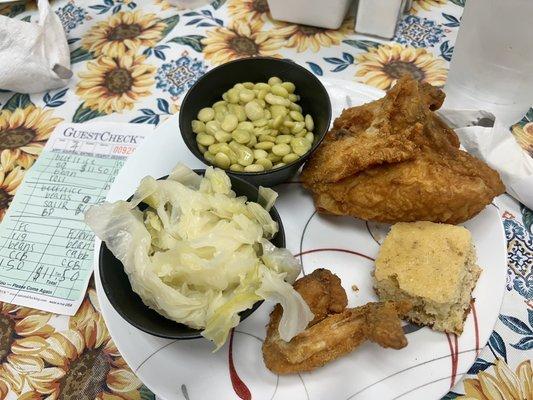 Fried chicken with cabbage, butter beans, and cracking bread.