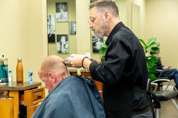 Stylist Brian providing an I-Catchers client with a Men's Cut.