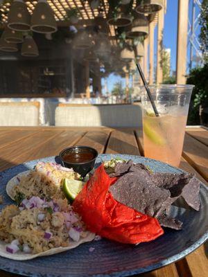 Patio seating with a nice strong mixed drink, chips and a pair of chicken and carnitas tacos