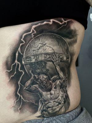 Black and grey Atlas tattoo