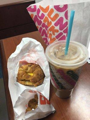 Pumpkin iced latte, chicken croissant, and hash browns