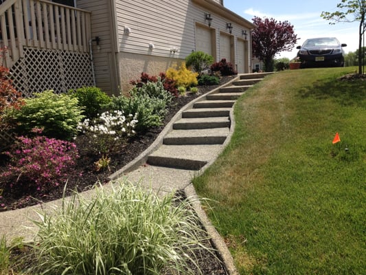 Sloped pool access issue resolved & aesthetically upgraded with exposed aggregate concrete & planting.