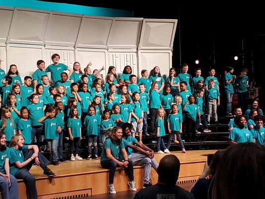 Ms.Oberoi with students on stage