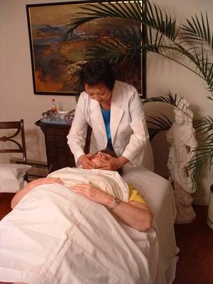 Dr. Chow working on a client.