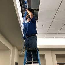 Installing communications cabling.