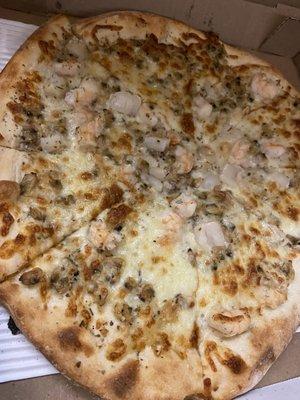 Seafood Pizza is a delicious combination of garlic, scallops, shrimp and clams.  Just perfection.