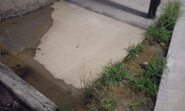 Flooded sidewalks and poor landscaping.