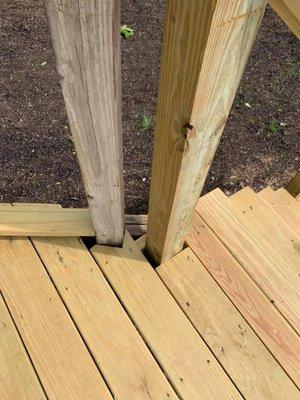 Poor job at decking around railing.