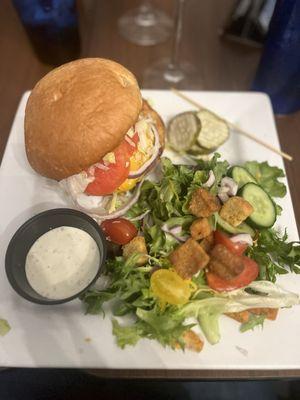 Cheese burger with a side salad with homemade ranch dressing