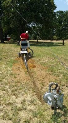 Digging out a trench line to repair/replace a leaking gas line.