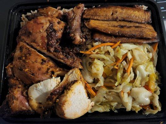 Jerk chicken plate with cabbage, rice & peas, and plantains.