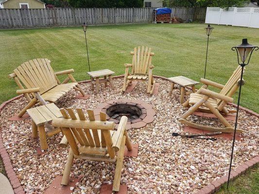 Lakeland Rocking chairs, loveseats, and end tables around a firepit