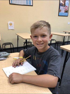 3rd boy working on 6th grade math and reading