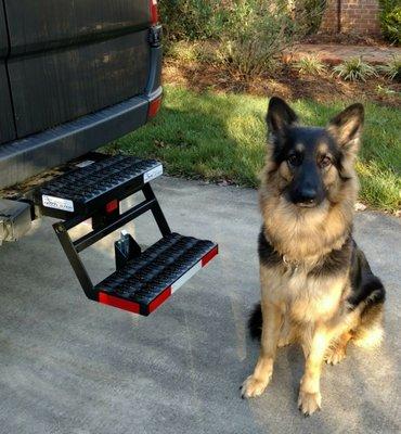 I got these cool folding hitch steps for my one-day-to-be expedition MB 4WD Sprinter. Stella thinks they're cool too. I added the reflectors