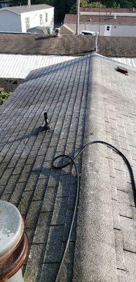 Roof cleaning in progress with our low pressure chemical softwash