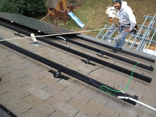 Installation on a steep roof.  Note the smile, we love roof work.