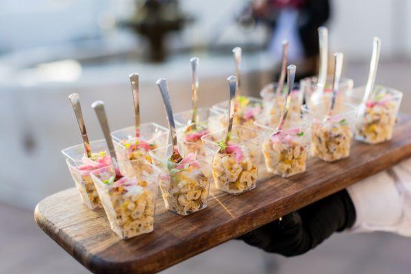 Enjoy the miniature delight of our elote cups: a burst of flavor in every bite-sized serving.