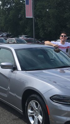 Anthony posing next to the new Dodge Charger