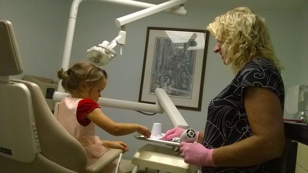 Dr. Mary Beth explaining how everything worked for filling a cavity.