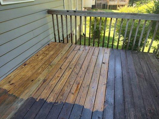 In progress pressure washing a deck